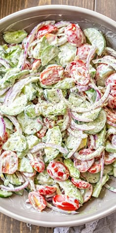 a bowl filled with cucumber and tomato salad