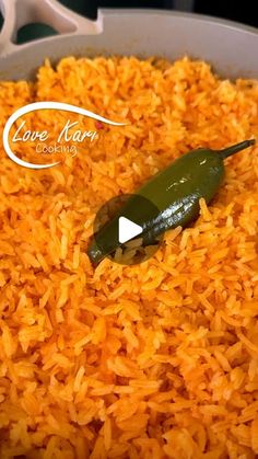 a pan filled with rice and a green pepper