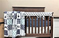 a baby crib with a blue and white blanket on it