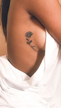 a woman with a rose tattoo on her back