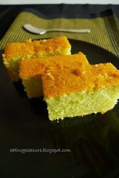 two pieces of cake sitting on top of a black plate