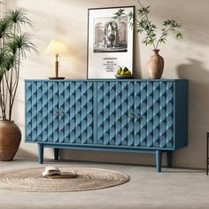 a blue cabinet sitting next to a plant in a living room with a rug on the floor