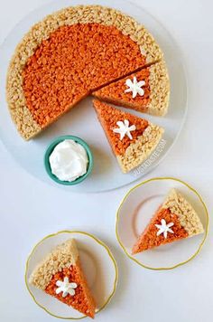 an orange cake with white flowers on it and three slices missing from the pie,