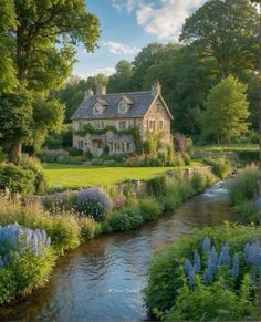 the house is surrounded by beautiful flowers and greenery, along with a river running through it