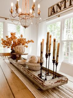 a wooden table topped with lots of candles