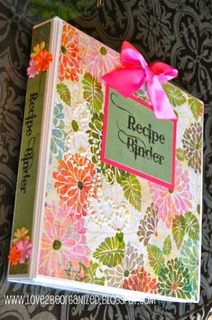 the recipe book is decorated with flowers and ribbons