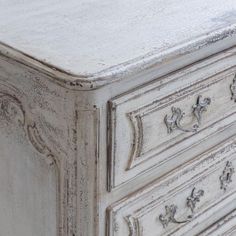 an old white dresser with ornate carvings on the top and drawers, painted in chalk paint