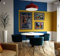 an image of a dining room setting with blue and yellow colors on the wall behind the table