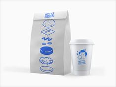 a coffee cup next to a paper bag with the words hey's burgerers on it