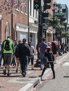 people walking down the street in front of buildings