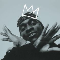 a black and white photo of a man with his hands in the air, wearing a bandana