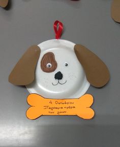 a paper plate shaped like a dog with a bone hanging from it's side