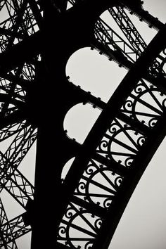 the eiffel tower is silhouetted against an overcast sky