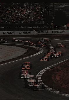 a group of cars driving down a race track