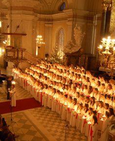 a large group of people with candles in front of them