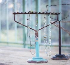 a hanukkah with beads and chains hanging from it's sides on a wooden table