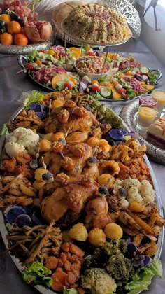 several platters filled with different types of food