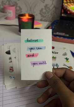 someone holding up a card that says believe you can and you will