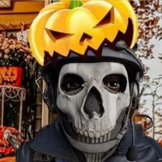 a skeleton wearing a helmet with a jack o lantern on it's head