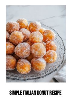 a plate filled with sugar covered donuts on top of a white marble countertop