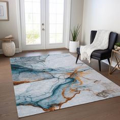 a living room area with a rug, chair and door in the background that has a marble design on it