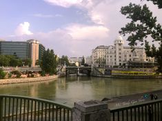 a river running through a city next to tall buildings