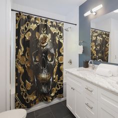 a bathroom with a skull shower curtain in it