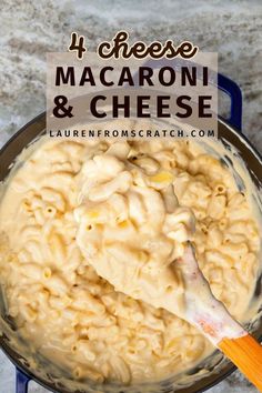 macaroni and cheese in a pan with a wooden spoon