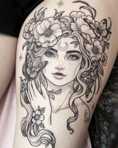 a woman's face with flowers and butterflies in her hair, on the thigh