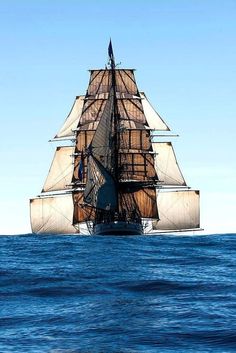 an old sailing ship in the middle of the ocean