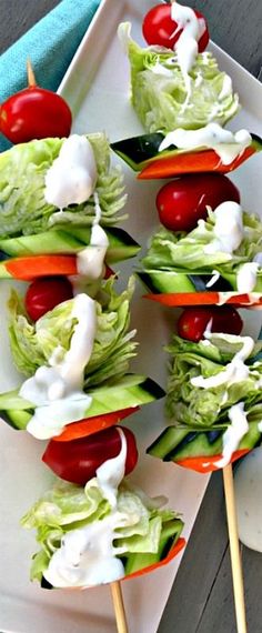 several skewers filled with lettuce and tomatoes