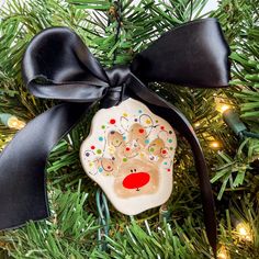 a decorated ornament hanging from a christmas tree