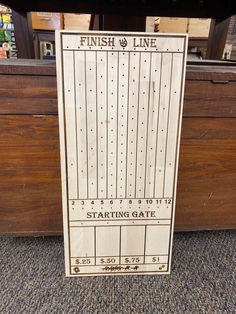 a wooden sign that says finish line starting gate