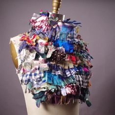 a mannequin with many different pieces of fabric on it