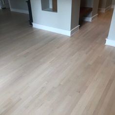 an empty living room with hard wood floors