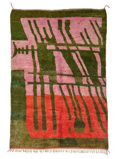 a green, pink and black rug with fringes on the bottom is shown in front of a white background