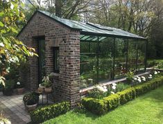 a small brick building with a green roof