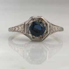 Details: Stunning Art Deco Period platinum and sapphire ring--would make a lovely wedding ring! The center stone is estimated .40 carats, and measures 4.9mm round. The filigree is beautiful on this ring, and is in lovely shape. This is a stunning ring--you will not be disappointed! Please ask all necessary questions prior to placing an order. Measurements: The size is 5 1/2 US and can be sized for a fee. Condition: The overall all condition of this ring is very good. Art Deco Sapphire Ring With Platinum Center Stone, Asscher Cut Sapphire Ring In Platinum, Classic Diamond Ring With Lab-created Sapphire Halo Setting, Diamond Cut Sapphire Diamond Rings, Sapphire Diamond Cut Ring, Heirloom Sapphire Ring In Silver, Asscher Cut, Formal Round Lab-created Sapphire Ring, Formal Lab-created Sapphire Round Ring, Sapphire Colored Diamond Rings With Diamond Cut