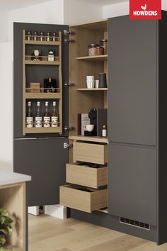 an open cabinet with spices and condiments on the shelves in front of it