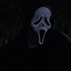 a person wearing a mask in the dark