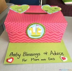 a pink box with an elephant and giraffe design on the lid that says, baby blessing & advice for mom and dad