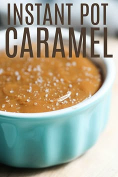 a blue bowl filled with caramel sauce on top of a wooden table