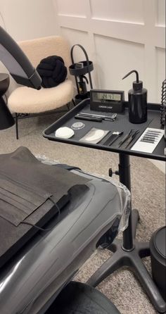 an office chair and desk with various items on it