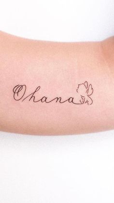 a woman's arm with a tattoo that reads, ohana on the side