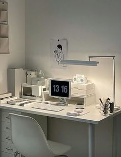 a white desk with a computer on top of it