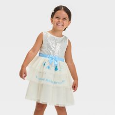 Dress up your little one like a sweet princess with this Disney Cinderella Sparkle Dress. This off-white sleeveless dress features a crew neckline, sequin-embellished bodice and tiered mesh skirt with Cinderella-themed print on front. Plus, a blue satin bow belt adds extra charm and appeal. The midweight fabric with lining offers comfy wear, while the back buttons make dressing them hassle-free. Cinderella Toddler Dress, Cinderella Sparkle, Cinderella Tutu Dress Birthday, Toddler Cinderella Shoes, Ballerina Tutu Dress, Cinderella Tutu Dress, Cinderella Dress For Girls, Pink Tutu Dress, Velour Dress