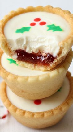 three cookies with icing and candy on them are stacked up next to each other