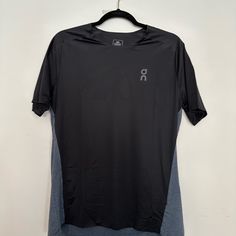 a black and grey shirt hanging on a hanger