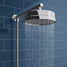 a shower head with water running from it in a blue tiled wall mounted showerhead