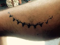 a man's arm with black ink on it